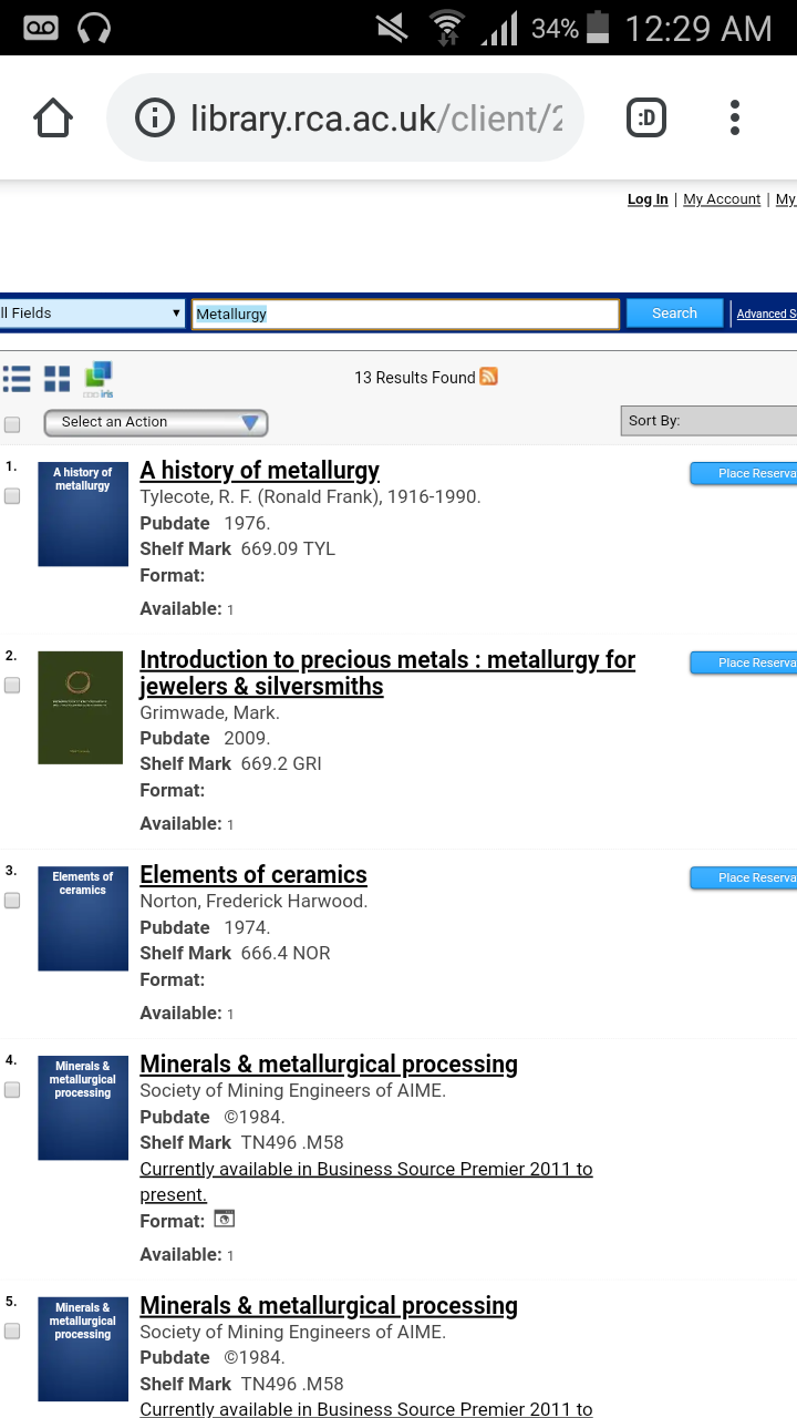 A screenshot of a search in the Royal College of Art Online Library Catalogue at 12:29AM with earphones connected, a voice message notification, on silent, connected to wifi and 34% battery left. 13 results found for the keyword metallurgy: A history of metallurgy, Introduction to precious metals: metallurgy for jewelers and silversmiths, Elements of ceramics, Minerals and metallurgical processing are visible search results.
